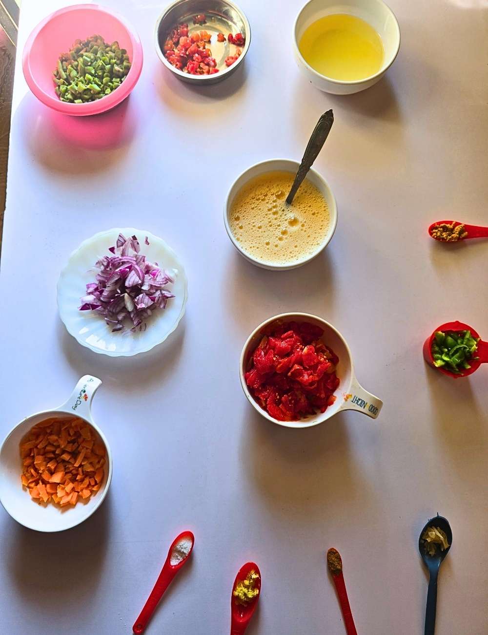 Ingredients for egg sauce recipe including eggs, tomatoes, carrots, and green beans
