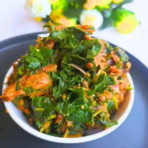 Plate of Nigerian vegetable stew with white rice, ready to serve for a healthy dinner